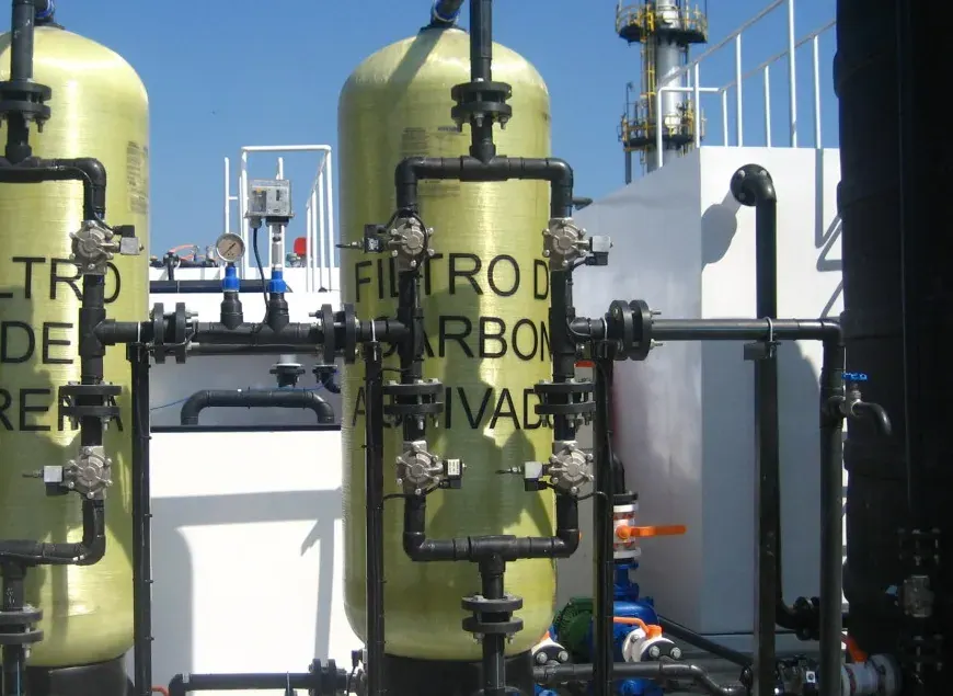 Two FRP pressure filters with valves and black pipework, installed on site.